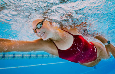 A women swimming in a pool at Club La Santa Lanzarote, taking part in the Swim Camp event.
