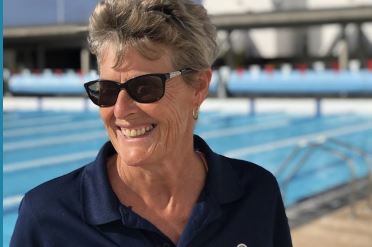 Rose Jones posing for a picture next to a pool at Club La Santa Lanzarote.