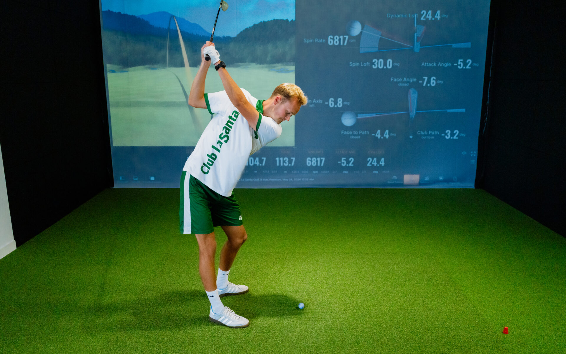 A man taking part in the trackman indoor golf simulator at Club La Santa Lanzarote.