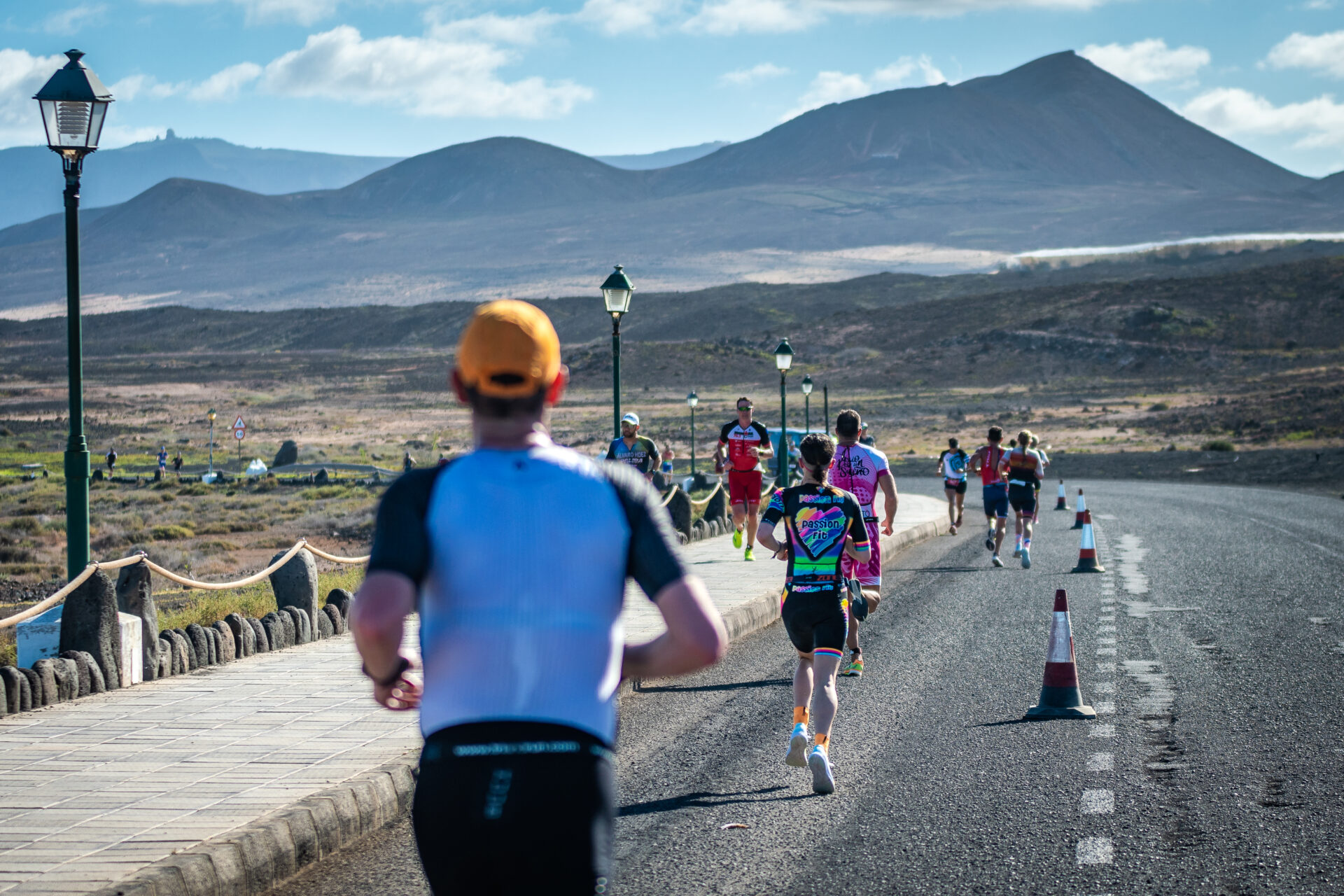 A group of people running in Lanzarote, taking part in the Long Distance Triathlon at Club La Santa